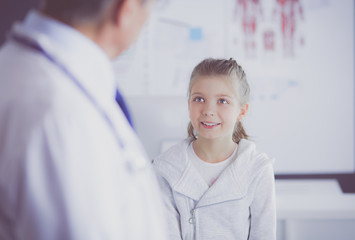 Fototapeta premium Portrait of a cute little girl and her doctor at hospital