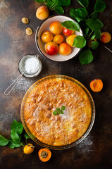Sponge cake with apricots, dusted with icing sugar