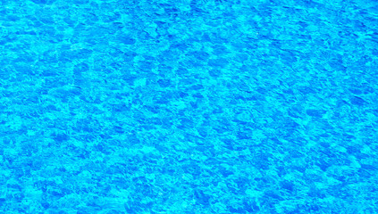 Fototapeta na wymiar The water surface of the swimming pool turquoise color, illuminated by the sun