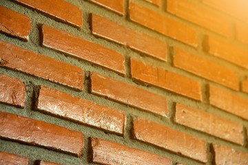 Brick wall texture closeup with  orange light.