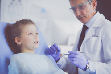 Fototapeta premium Little girl sitting in the dentists office