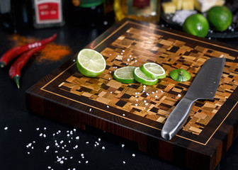 Beautiful wooden cutting board with lime slices
