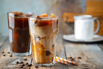 Ice coffee in a tall glass with cream.