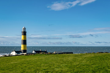 Obraz premium This is a picture of St John's Point Lighthouse on the east coast of Northern Ireland on the Irish Sea. It is one of Irelands many iconic coastal lighhouses