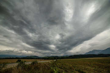 Naklejka na ściany i meble storm clouds over fields in slovakia