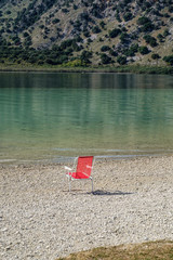 Red Chair at the shore of Lake Kournas, Crete, Greece