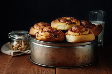 Freshly baked cinnamon buns with spices and cocoa filling. Sweet Homemade Pastry, dessert.