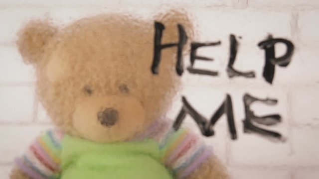 Forgotten toy. Child abuse concept. The bear cub asks for help.
