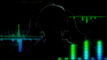 Deejay in headphones playing and mixing music on equalizer effects background