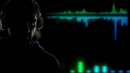 Male in headphones listening sound, looking into future innovation progress