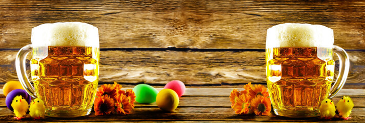 Glass of cold light beer with Easter decorations on a wood background for the Easter holidays