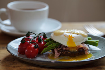 Breakfast with mushroom, poached egg, asparagus and tomatoes