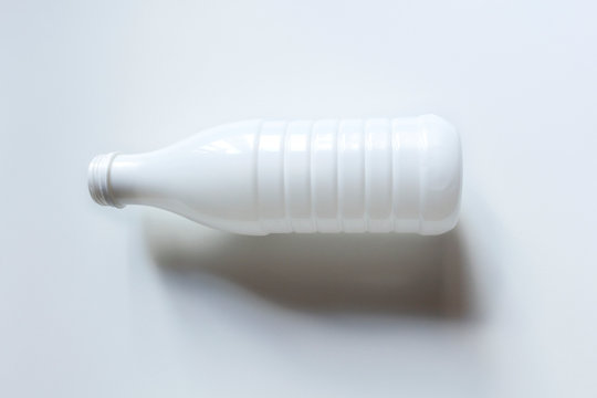 Open White Plastic Milk Bottle On White Background