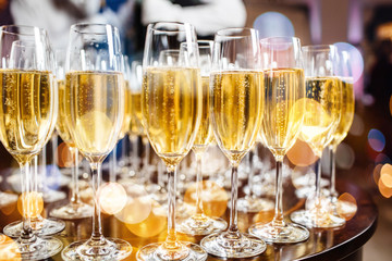 Champagne glasses on sparkling background.