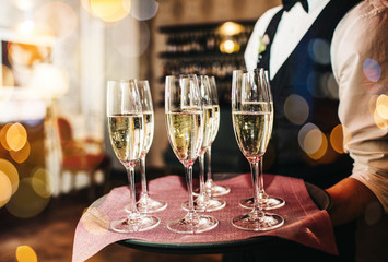 Champagne glasses on sparkling background.