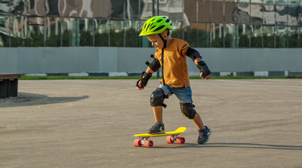 A little boy enjoys a yellow cruiser penny plastboard