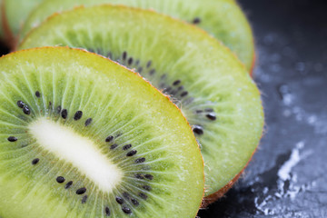 Fresh green sliced kiwi on a slate board