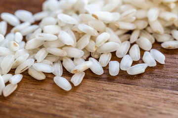 Close up of white raw rise on a wooden table