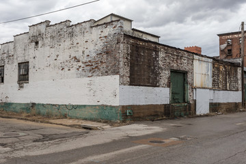 Fototapeta na wymiar Worn out old abandoned building in depressed urban area