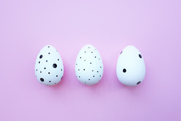White three easter eggs on pink background. Background with easter eggs.