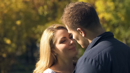 Smiling woman looking with love at boyfriend, dreaming to kiss beloved man
