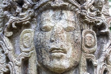 Mayan Face Carved in Stone Temple Building in World Famous Copan Ruins Archeological Site of ancient Maya Civilization, a UNESCO World Heritage Site in Honduras near Guatemala Border