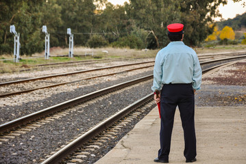 Station manager waiting for the train to pass, Caracollera, Ciudad Real, Spain.