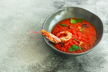Gazpacho soup with prawns shrimps (tomato red soup with seafood) portion. food background. copy space