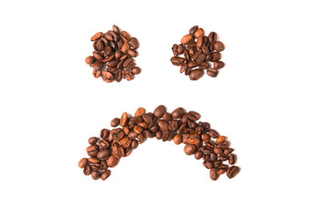 Coffee beans. Sad smile on white background.