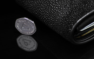 UAE - 50 Fils Coin And Sting Ray Wallet On A Black Shiny Background