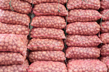 stack of sacks full of potato in the general flat market