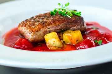 duck breast roasting, vegetables, berry sauce and microgreen (main dish). food background. top view
