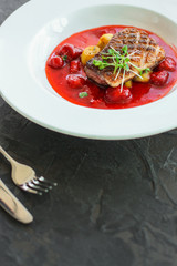 duck breast roasting, vegetables, berry sauce and microgreen (main dish). food background. top view