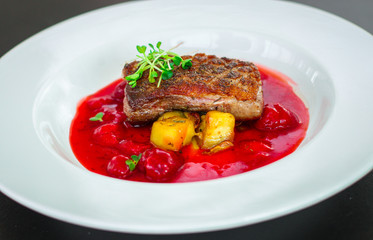 duck breast roasting, vegetables, berry sauce and microgreen (main dish). food background. top view