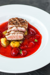 duck breast roasting, vegetables, berry sauce and microgreen (main dish). food background. top view