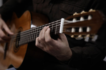 Fototapeta na wymiar man playing acoustic guitar