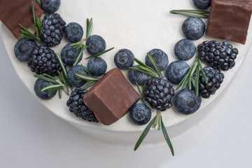 Appetizing cake with berries, rosemary over the cake. Close up. Copy space. Stollen cake background. Christmas pie, cake. Healthy sweets concept. Small business background. Web page saver