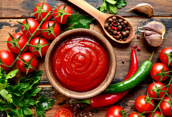 Fresh homemade ketchup with ingredients for making.Top view with copy space. - obrazy, fototapety, plakaty