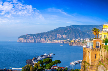 Seascape beautiful famous coastline. Yachts, boats and boats in the harbor. Seaside panoramic view of Sorrento, Naples, Campania, Italy.