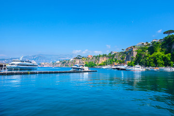 Fototapeta na wymiar Seascape beautiful famous coastline. Yachts, boats and boats in the harbor. Seaside panoramic view of Sorrento, Naples, Campania, Italy.