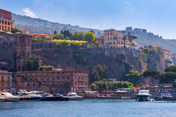 Seascape beautiful famous coastline. Yachts, boats and boats in the harbor. Seaside panoramic view of Sorrento, Naples, Campania, Italy.