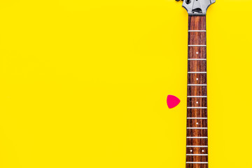 Fototapeta premium Musician work place with guitar on yellow background top view mock up