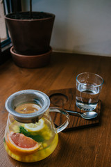 Ginger tea with mint and lemon and grapefruit. Herbal healthy drink in the teapot in local cafe