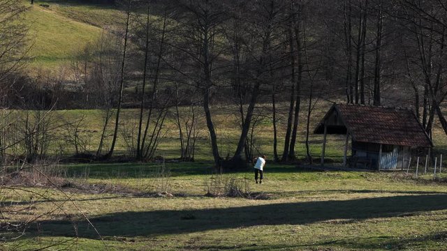 Woman clean field of meadow - (4K)