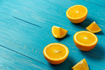 Row of fresh oranges, top view. Healthy citrus fruits on blue wooden background, top view, copyspace.