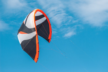 colorful sail from kitesurfing on a background of blue sky