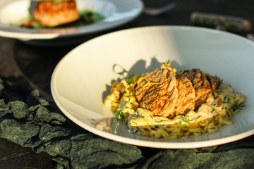 roast meat, pasta Annellini and creamy sauce (main dish). food background. top view