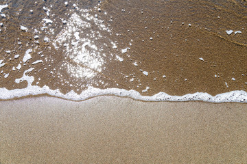 Wave on the sand beach background 