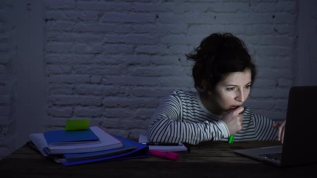 4k wide slider video of Overworked and tired female student falling asleep on the desk while working late at night on her computer laptop. In studying for final exams and overworked concept.