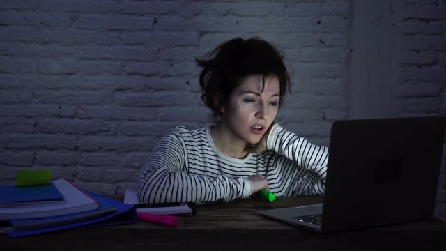 4k wide slider video of Overworked and tired female student falling asleep on the desk while working late at night on her computer laptop. In studying for final exams and overworked concept.